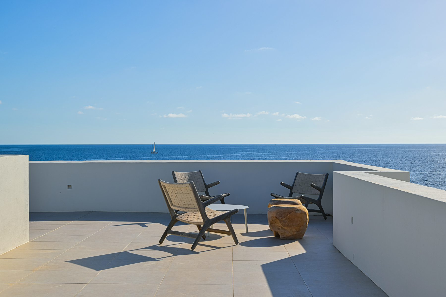 Take in the panoramic sea views from the private roof terrace of this stunning modern villa on the seafront in Menorca.