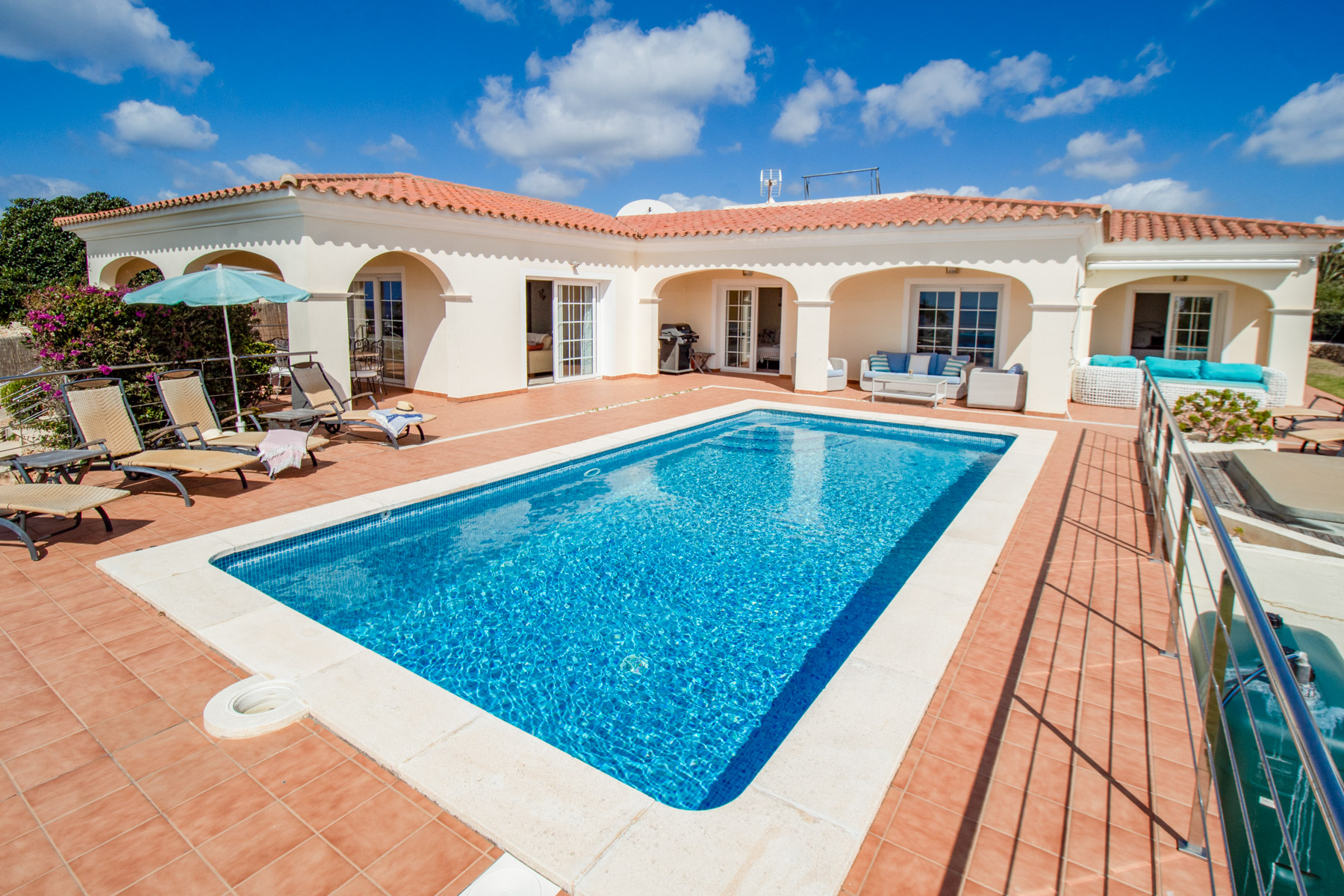 Take in panoramic sea views from the roof terrace, enjoy a game of ping pong or relax by the heated pool at this charming family villa in Menorca.